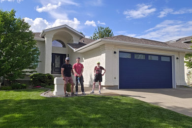 Mid-sized white split-level stucco house exterior idea in Edmonton