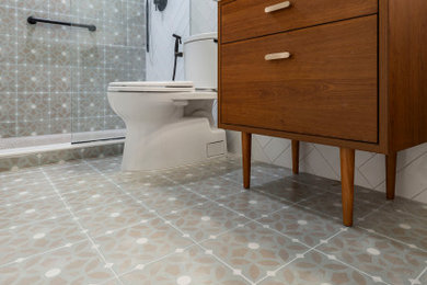 Bathroom - mid-sized mid-century modern master green tile and porcelain tile porcelain tile, green floor, single-sink and wainscoting bathroom idea in DC Metro with flat-panel cabinets, medium tone wood cabinets, a two-piece toilet, green walls, a drop-in sink, solid surface countertops, white countertops, a niche and a freestanding vanity