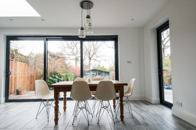Medium sized modern open plan dining room in London.