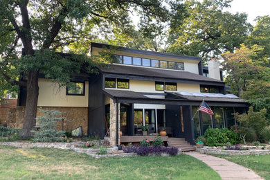 Large mid-century modern exterior home photo in Other