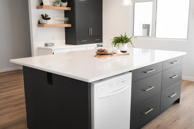 Inspiration for a mid-sized transitional l-shaped kitchen remodel in Edmonton with flat-panel cabinets, gray cabinets, quartz countertops, an island and white countertops