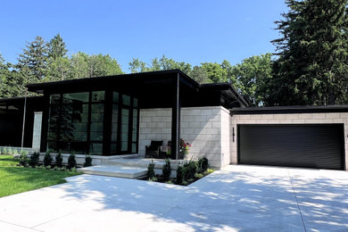 Inspiration for a large modern multicolored one-story stone exterior home remodel in Toronto