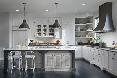 Photo of an expansive transitional l-shaped open plan kitchen in Minneapolis with flat-panel cabinets, white cabinets, quartz benchtops, white splashback, panelled appliances and with island.