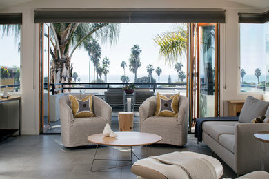 Example of a beach style gray floor living room design in San Diego with white walls