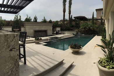 Mid-sized backyard rectangular pool fountain photo in Orange County