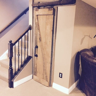 Large rustic fully buried basement in Columbus with brown walls, carpet, no fireplace and brown floors.