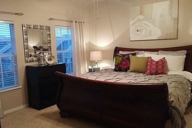 Large transitional master carpeted bedroom photo in Orlando with beige walls and no fireplace