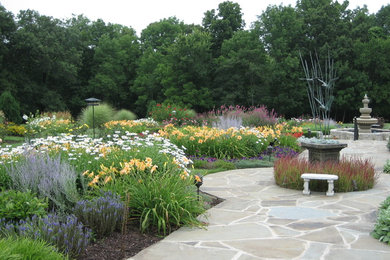 Inspiration for a traditional backyard formal garden in Chicago with a garden path and natural stone pavers.