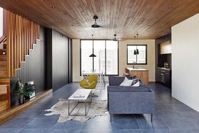 Photo of a contemporary open concept living room in Townsville with ceramic floors, grey floor and black walls.