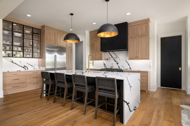 Mid-sized transitional light wood floor kitchen photo in Milwaukee with an undermount sink, flat-panel cabinets, light wood cabinets, quartz countertops, multicolored backsplash, stone slab backsplash, stainless steel appliances, an island and multicolored countertops
