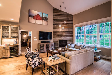 Mid-sized transitional open concept light wood floor living room photo in Denver with beige walls, a standard fireplace, a wood fireplace surround and a wall-mounted tv