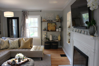Inspiration for a mid-sized eclectic enclosed medium tone wood floor living room remodel in Indianapolis with gray walls, a standard fireplace, a tile fireplace and a wall-mounted tv