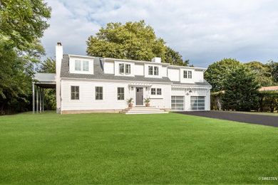 Mid-sized transitional white two-story concrete fiberboard house exterior idea with a shed roof and a mixed material roof