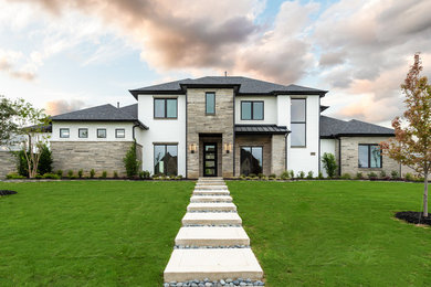 Photo of a contemporary two-storey brick white house exterior in Dallas with a shingle roof.