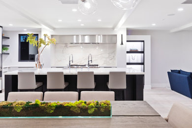 Inspiration for a large contemporary u-shaped light wood floor and gray floor eat-in kitchen remodel in Orange County with an undermount sink, flat-panel cabinets, black cabinets, marble countertops, white backsplash, stone slab backsplash, stainless steel appliances, an island and white countertops