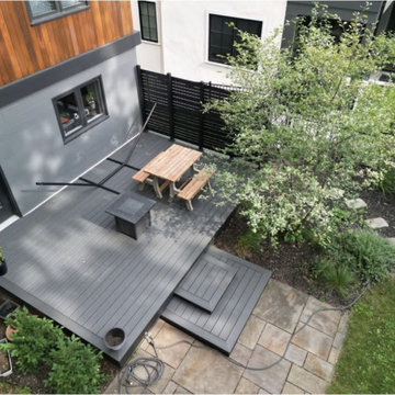 Modern Ground-Level Gray Composite Deck with Privacy Screen