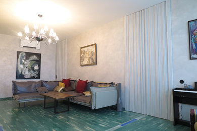 На фото: большая гостиная комната в современном стиле с серыми стенами, деревянным полом, горизонтальным камином, телевизором на стене и зеленым полом с