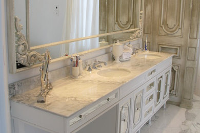 Bathroom - mid-sized traditional master marble floor bathroom idea in Montreal with a drop-in sink, distressed cabinets, marble countertops and white walls