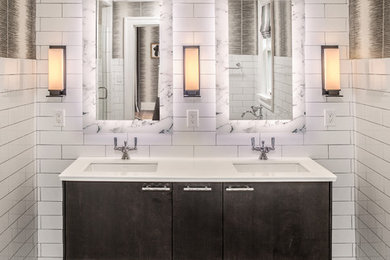 Photo of a small contemporary master bathroom in Milwaukee with dark wood cabinets, white tile, subway tile, white walls, an undermount sink, marble benchtops, multi-coloured floor and flat-panel cabinets.