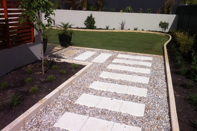 Large contemporary backyard full sun formal garden in Perth with a garden path and brick pavers for summer.