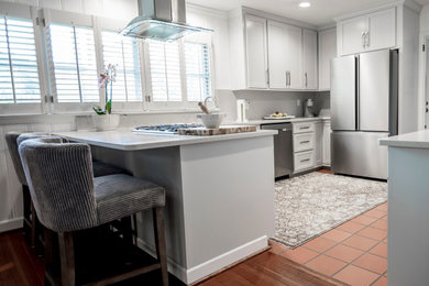 Example of a mid-sized trendy u-shaped eat-in kitchen design in Raleigh with shaker cabinets, white cabinets and white countertops
