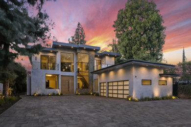 Inspiration for a large contemporary gray two-story concrete exterior home remodel in Los Angeles