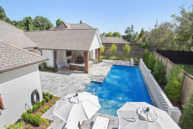 Pool - mid-sized contemporary backyard stone and rectangular pool idea in Other
