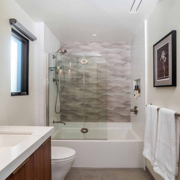 Modern Bathroom with Wood Vanity, Backlit Mirror, and Tub Shower Combo