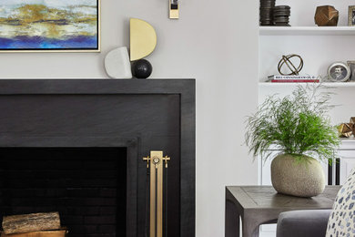 Mid-sized trendy formal and enclosed medium tone wood floor living room photo in New York with gray walls, a standard fireplace, a metal fireplace and no tv
