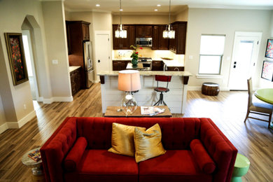 Example of a small classic u-shaped light wood floor open concept kitchen design with an undermount sink, raised-panel cabinets, dark wood cabinets, granite countertops, beige backsplash, stainless steel appliances and two islands