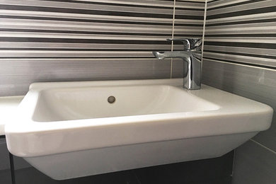 This is an example of a medium sized contemporary family bathroom in Buckinghamshire with an alcove bath, a one-piece toilet and black and white tiles.
