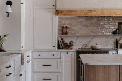 Large transitional l-shaped porcelain tile, beige floor and shiplap ceiling enclosed kitchen photo in Other with an undermount sink, shaker cabinets, white cabinets, solid surface countertops, beige backsplash, cement tile backsplash, stainless steel appliances, an island and white countertops