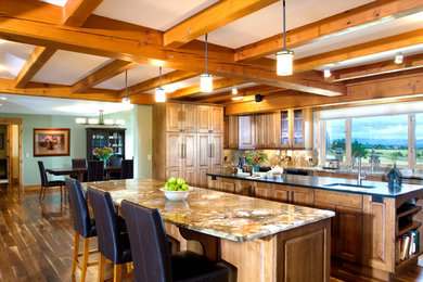 Eat-in kitchen - rustic u-shaped eat-in kitchen idea in Other with an undermount sink, raised-panel cabinets, medium tone wood cabinets, granite countertops, multicolored backsplash, stone slab backsplash and stainless steel appliances