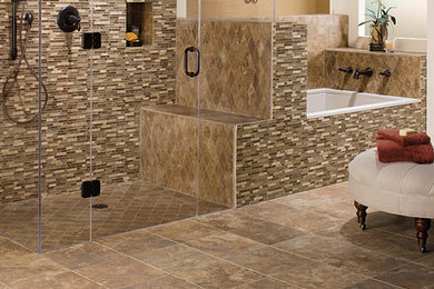 Design ideas for a mid-sized master bathroom in Other with a drop-in tub, a curbless shower, beige tile, brown tile, gray tile, multi-coloured tile, matchstick tile, beige walls, travertine floors, brown floor and a hinged shower door.