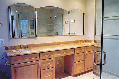 Corner shower - mid-sized beige tile corner shower idea in Other with light wood cabinets and beige walls