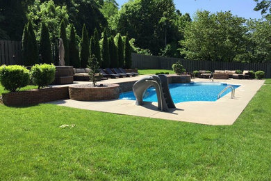 Mid-sized elegant backyard concrete and rectangular lap pool photo in Other