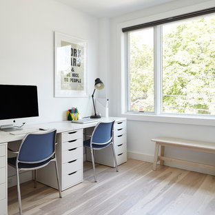 Design ideas for a small modern home studio in Toronto with white walls, light hardwood flooring, a freestanding desk and multi-coloured floors.