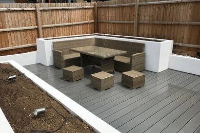 Modern rendered raised beds with composite decking.