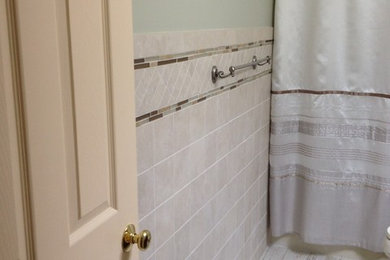 Bathroom - small shabby-chic style kids' beige tile and porcelain tile porcelain tile bathroom idea in Other with an undermount sink, raised-panel cabinets, medium tone wood cabinets, granite countertops, a one-piece toilet and green walls