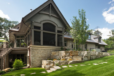 Inspiration for a large traditional front yard full sun xeriscape in Minneapolis with natural stone pavers.