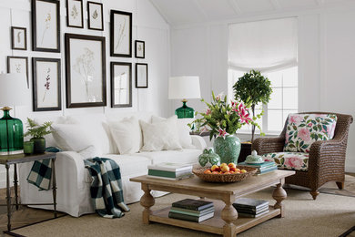 Example of a mid-sized farmhouse open concept light wood floor living room design in Orlando with white walls