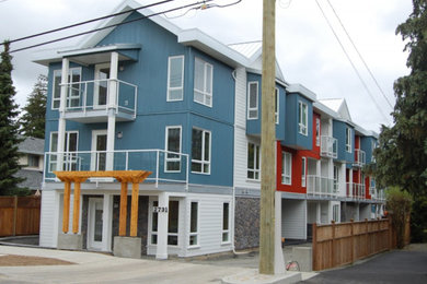 This is an example of a small contemporary three-storey townhouse exterior in Other with metal siding.