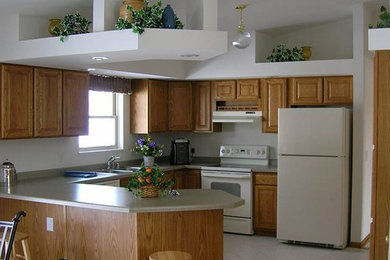 Example of an u-shaped eat-in kitchen design in Other with beaded inset cabinets, light wood cabinets, granite countertops and white appliances