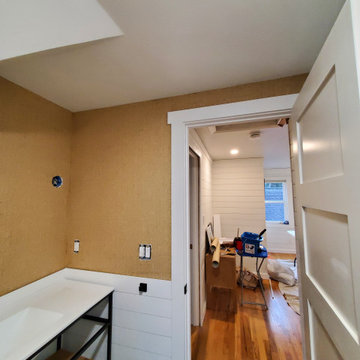 Wallpapering in a bathroom with grasscloth material