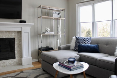 Inspiration for a contemporary open concept light wood floor family room remodel in Toronto with gray walls, a standard fireplace, a wood fireplace surround and a wall-mounted tv