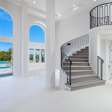 Curved Staircase with Geometric Iron Railing & Balcony Overlook – Newport Coast