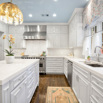 Bright and Elegant Kitchen with Glass Dining Table and Custom Cabinetry