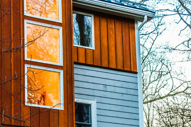 Mid-sized trendy brown two-story wood exterior home photo in Boston with a metal roof