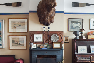 Example of a classic medium tone wood floor living room design in Philadelphia with beige walls and a standard fireplace