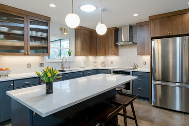 Eat-in kitchen - large 1960s l-shaped ceramic tile eat-in kitchen idea in Miami with an undermount sink, flat-panel cabinets, gray cabinets, quartz countertops, beige backsplash, subway tile backsplash, stainless steel appliances and an island